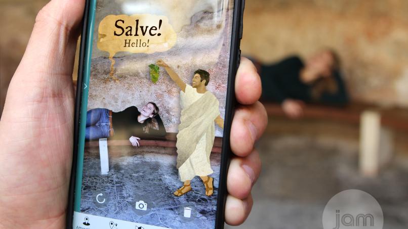 Image: A person using the World Heritage App at the Roman Baths